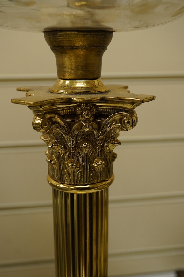 An Edwardian brass Corinthian columned oil lamp, 77cm high including funnel and shade. Condition - column good glass bowl, brass figments and funnel good, shade broken